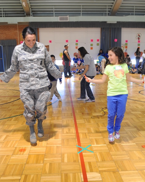 Senior Airman Sirenna Marindeleon, 7th Security Forces Squadron, jumps rope with her daughter Sophia, 9, during a jump-rope-for-hearts celebration at Dyess Elementary School, March 7, 2013, in Abilene, Texas. The celebration was held to raise money for the American Heart Association. The proceeds went toward research for heart disease, awareness and prevention. A percent also went towards new physical training equipment for the students. (U.S. Air Force photo by Airman 1st Class Cierra Presentado/ Released)
