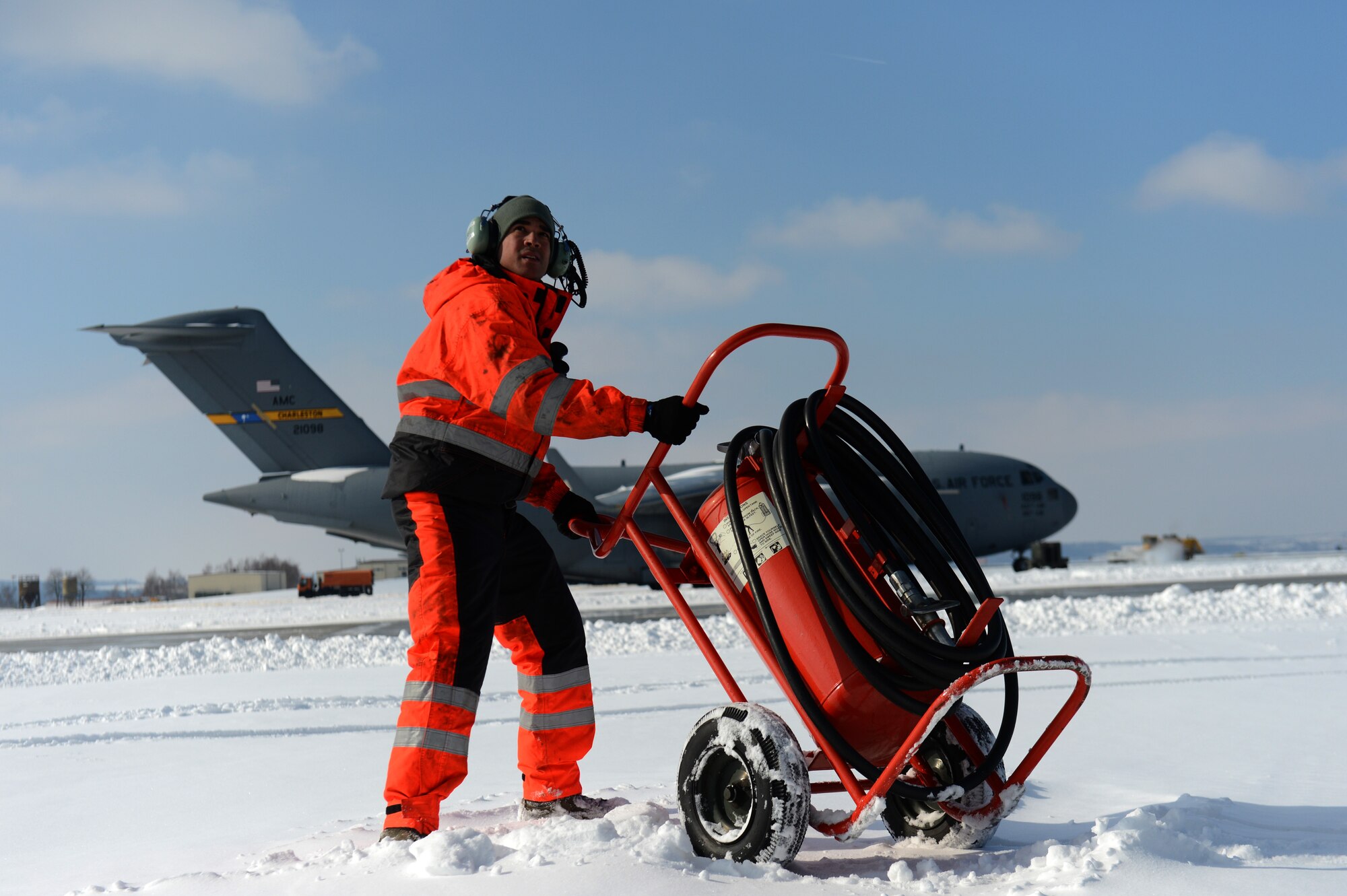 SPANGDAHLEM AIR BASE, Germany – U.S. Air Force Senior Airman Bryan Rodriguez, 726th Air Mobility Squadron electrical and environmental technician from Bayamon, Puerto Rico, positions a fire bottle on the flightline March 13, 2013. In case of emergency, the fire bottle produces ozone-depleting chemicals to extinguish fires. (U.S. Air Force photo by Airman 1st Class Gustavo Castillo/Released) 