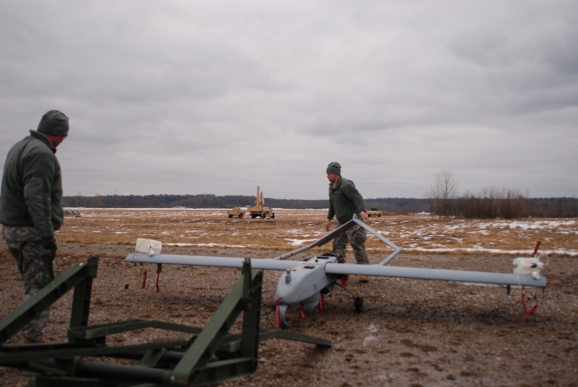 Members of the U.S. Army 76th Brigade Special Troops Battalion,
prepare to load a U.S. Army RQ-7, Shadow, unmanned aerial vehicle, onto the
launcher, during exercise Checkered Flag, Camp Atterbury, Ind., Mar. 7,
2013. (U.S. Air Force photo by Maj. Frank Howard/Release)

