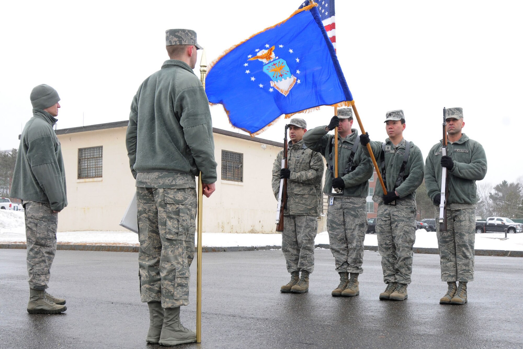 HANSCOM AIR FORCE BASE, Mass. -- Members of the Patriot Honor Guard dutifully train in the early hours of a snowstorm at a weekly practice session outside Building 1210 March 7. Honor guard members endure all temperatures and conditions throughout the year to perform honors for fallen veterans as well as other ceremonies. (U.S. Air Force photo by Linda LaBonte Britt)