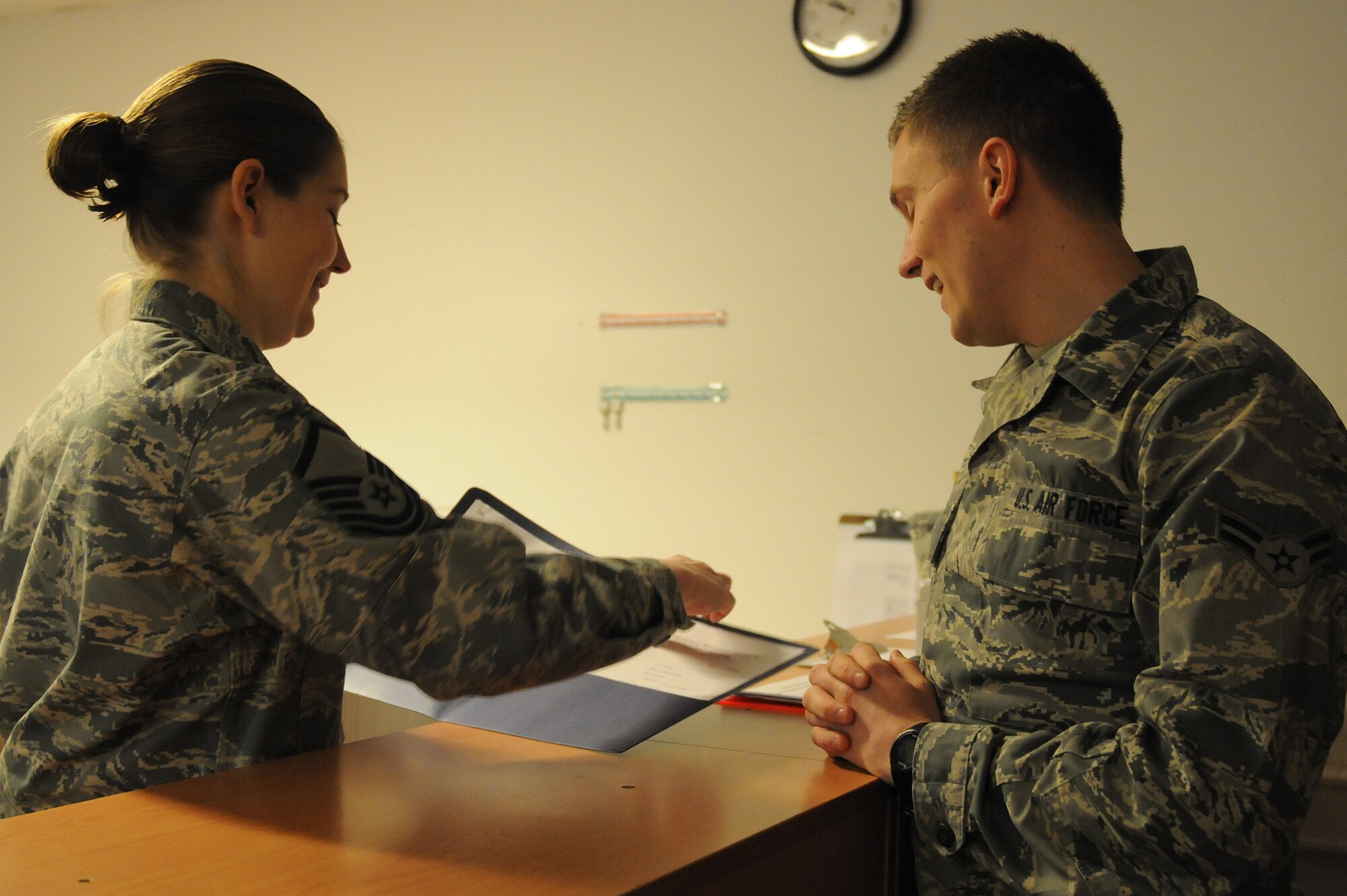 Master Sgt. Misti Rodriguez, 86th Civil Engineer Squadron unaccompanied housing superintendent, looks over housing paperwork for Airman 1st Class Zachary Bach, 2nd Air Postal Squadron knowledge operator, at the Dorm Reception Center on Ramstein Air Base, Germany, March 8, 2013. Rodriguez won the airman dorm leader superintendent award at this year’s U.S. Air Forces in Europe and Air Forces Africa first quarter awards ceremony. (U.S. Air Force photo/Airman 1st Class Holly Cook)