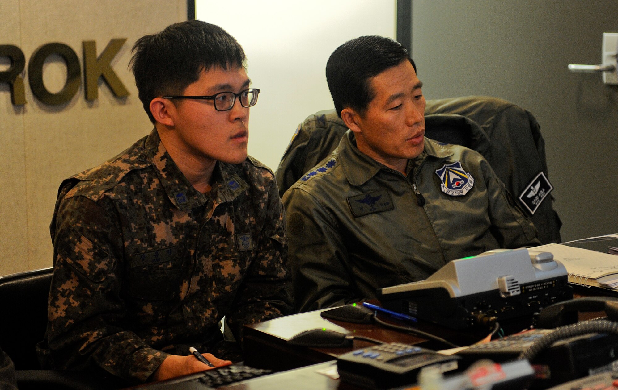 Republic of Korea Air Force Col. Kim Junsik, Operations Command operations division chief, addresses members of the command staff brief while ROKAF 2nd Lt. Jang Yu-chan, translates during Exercise Key Resolve on Osan Air Base, Republic of Korea, March 14, 2013. The United Nations Command notified the North Korean military Feb. 21 of the exercise dates and that Key Resolve is an annual ROK-U.S. combined exercise that is not related to current events on the Korean Peninsula. (U.S. Air Force photo/Staff Sgt. Zachary Wolf)