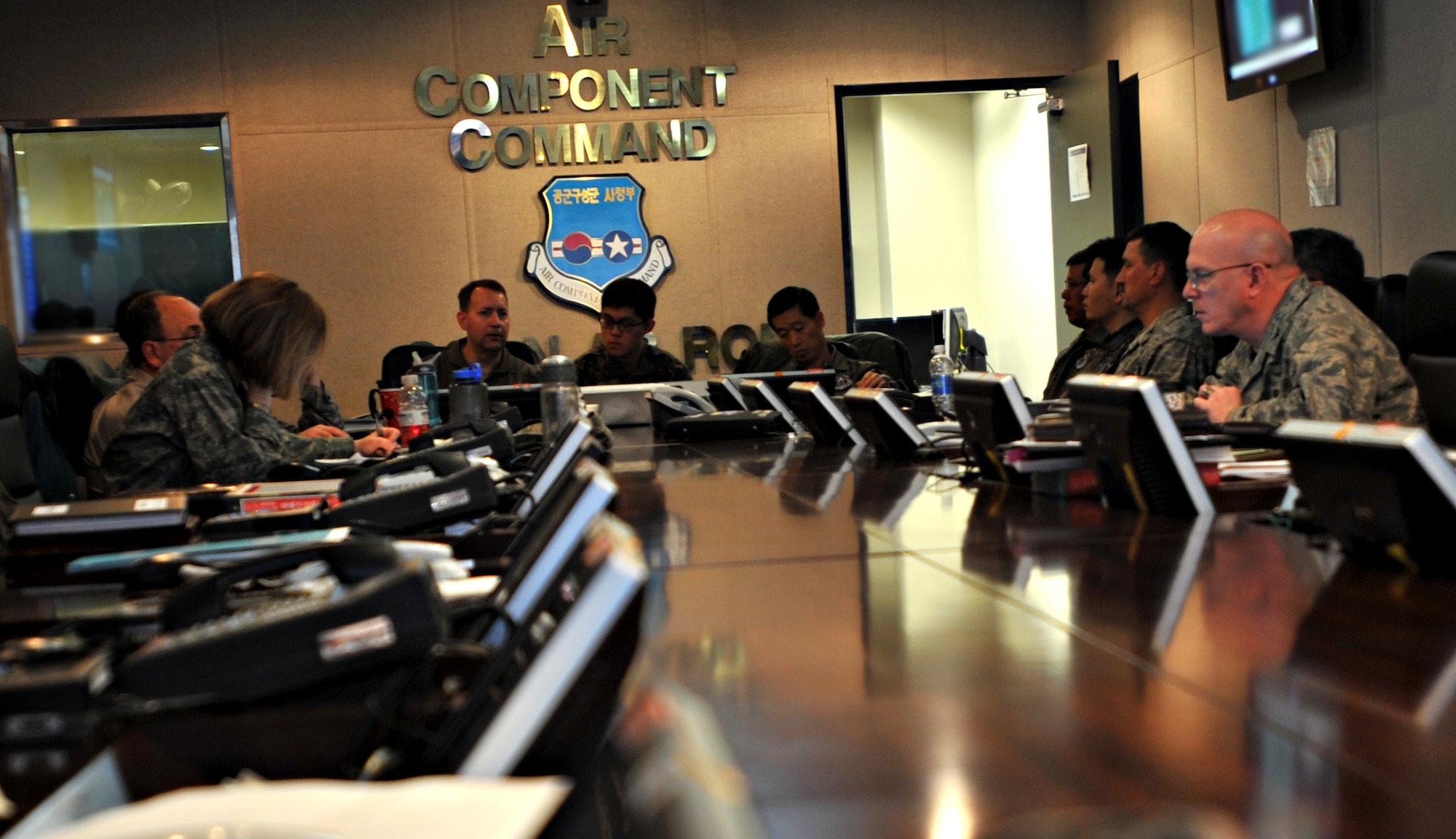 U.S. Air Force Col. David Avila, 7th Air Force operations and plans director, consults with staff members during a command staff briefing to kick off Exercise Key Resolve on Osan Air Base, Republic of Korea, March 14, 2013. Key Resolve is an annual combined and joint command post exercise designed to increase Alliance readiness on the Korean Peninsula. Participants in the exercise hone the skills necessary to defend the Republic of Korea, coordinate and execute the deployment of U.S. reinforcements, and maintain ROK military combat capabilities. (U.S. Air Force photo/Airman 1st Class Hailey R. Davis)