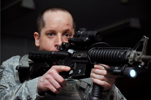 U.S. Air Force Master Sgt. Michael Grice, 35th Security Forces Squadron NCO in charge of police services, clears a classroom as he searches for a simulated active shooter during a Pacific Air Forces High Risk Response Training Exercise at Misawa Air Base, Japan, March 7, 2013. Participating in exercises like this helps Airmen of the 35th SFS develop the skills and knowledge to prepare for worst case scenarios. By continuing to outperform other bases in the Pacific, they earned the PACAF 2012 Outstanding Medium Security Forces Unit award. (U.S. Air Force photo by Airman 1st Class Zachary Kee) 