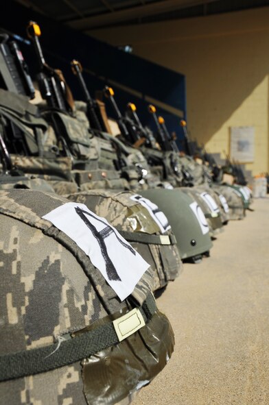 Security forces gear neatly lines the side of a wall  as 51st SFS members prepare for their morning physical training session during the Air Police Special Duty Team course at the JinJui Education and Training Command March 6, 2013. Each day of training started with a 40-minute ruck run or walk up to the training facilities followed by intense stretch and combat physical training sessions.(U.S. Air Force photo/Senior Airman Kristina Overton)