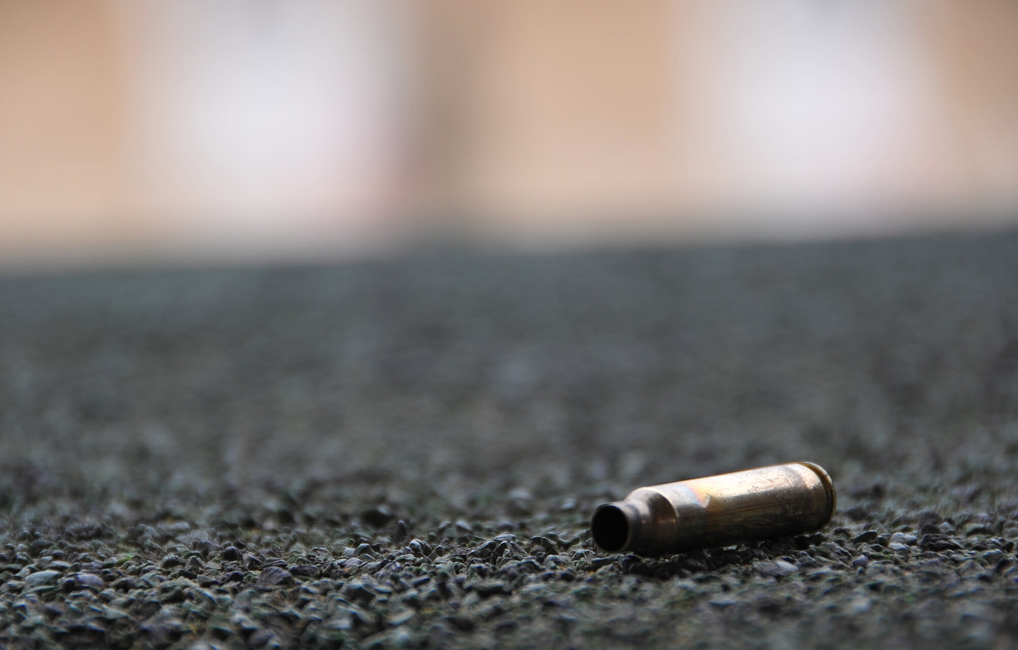 A lone ammunition shell lays on the ground during a firing session for training at the at the JinJui Education and Training Command March 7, 2013.  Ten members of the 51st Security Forces Squadron joined in a week-long ROKAF training course, which gave them an opportunity to share information, learn from, and practice techniques with their Korean counterparts. (U.S. Air Force photo/Senior Airman Kristina Overton)