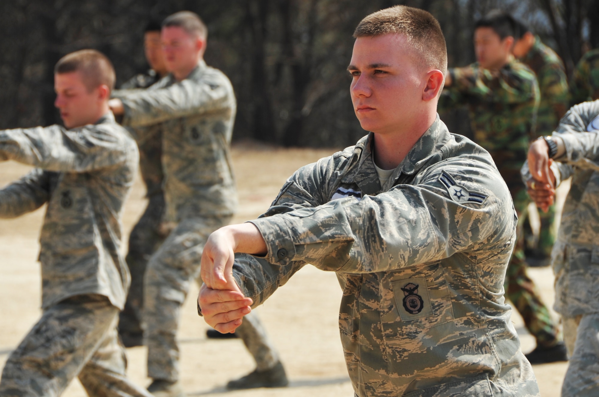 Airman 1st Class James Ross, 51st Security Forces Squadron entry controller, stands in formation for combat physical training during the Air Police Special Duty Team course at the JinJui Education and Training Command March 6, 2013.  Combat PT is similar to Cross Fit, working several muscle groups at the same time. (U.S. Air Force photo/Senior Airman Kristina Overton)