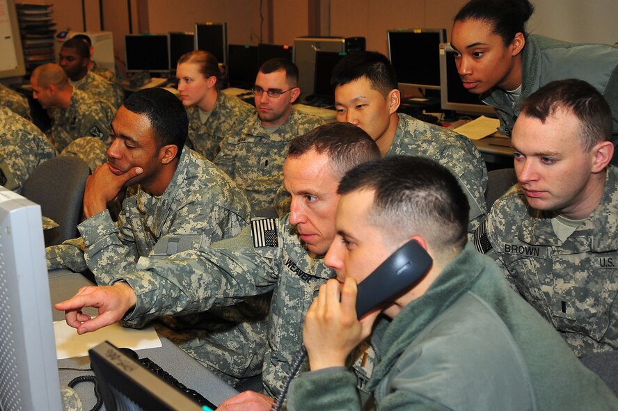 Theater missile operators from the Korea Air Simulation Center, plan out when and where to launch missile strikes during Key Resolve at bld. 946 on Osan Air Base, Republic of Korea, March 12, 2013.  The KASC uses modeling and simulation technology to enable computer and software tools to create graphically represented, synthetic environments for training and mission planning.   (U.S. Air Force photo/Staff Sgt. Emerson Nuñez) 
