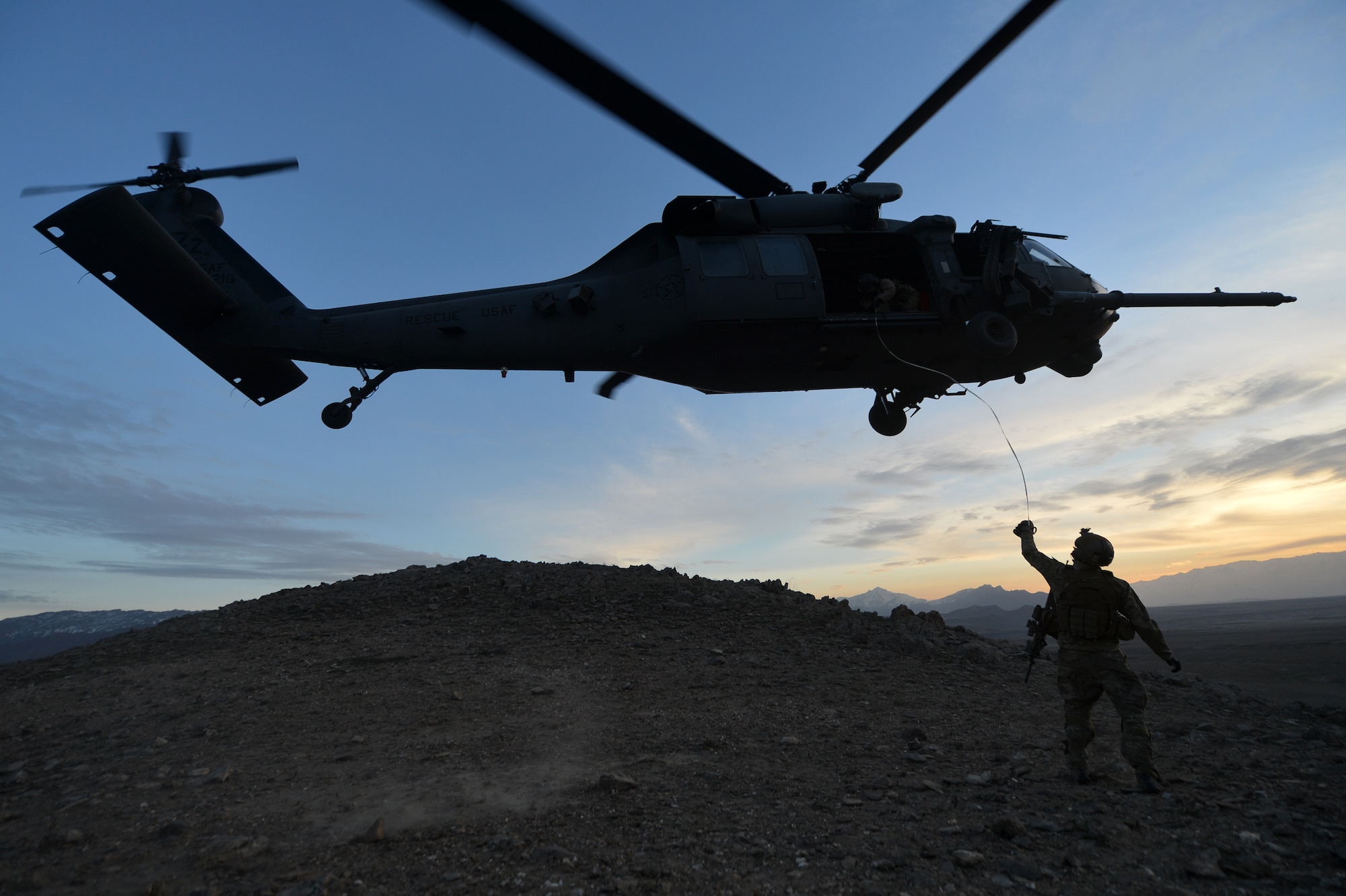 Staff Sgt. George Reed, 83rd Expeditionary Rescue Squadron pararescuemen, secures the tag lining for a patient being hoisted-up onto an HH-60G Pave Hawk outside of Bagram Airfield, Afghanistan, March 12, 2013. The 83rd ERQS Guardian Angel’s mission is to rescue, recover, and return American or allied forces in times of danger or extreme duress.  (U.S. Air Force photo/Senior Airman Chris Willis)