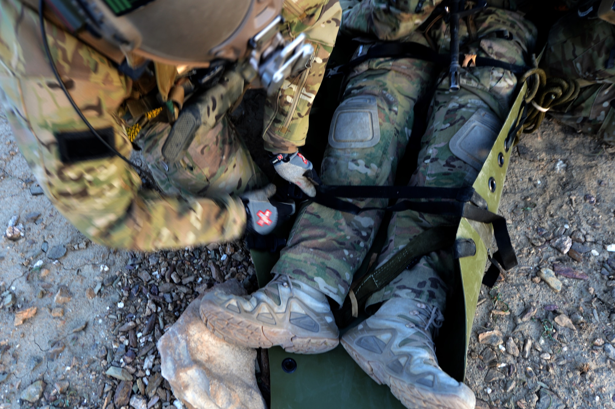 Members of the 83rd Expeditionary Rescue Squadron Guardian Angel attend to a simulated casualty during a training mission outside of Bagram Airfield, Afghanistan, March 12, 2013. The 83rd ERQS Guardian Angel is a small tactical unit that trains and executes their mission in personnel recovery throughout eastern Afghanistan. (U.S. Air Force photo/Senior Airman Chris Willis)