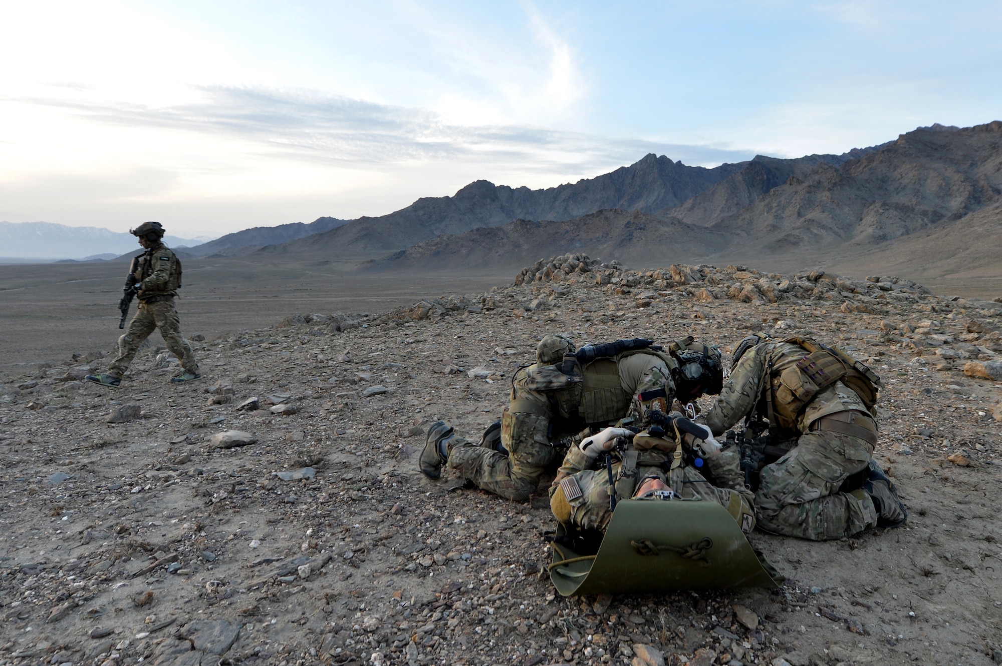 Members of the 83rd Expeditionary Rescue Squadron Guardian Angel attend to a simulated casualty during a training mission outside of Bagram Airfield, Afghanistan, March 12, 2013. The 83rd ERQS Guardian Angel is a small tactical unit that trains and executes their mission in personnel recovery throughout eastern Afghanistan. (U.S. Air Force photo/Senior Airman Chris Willis)