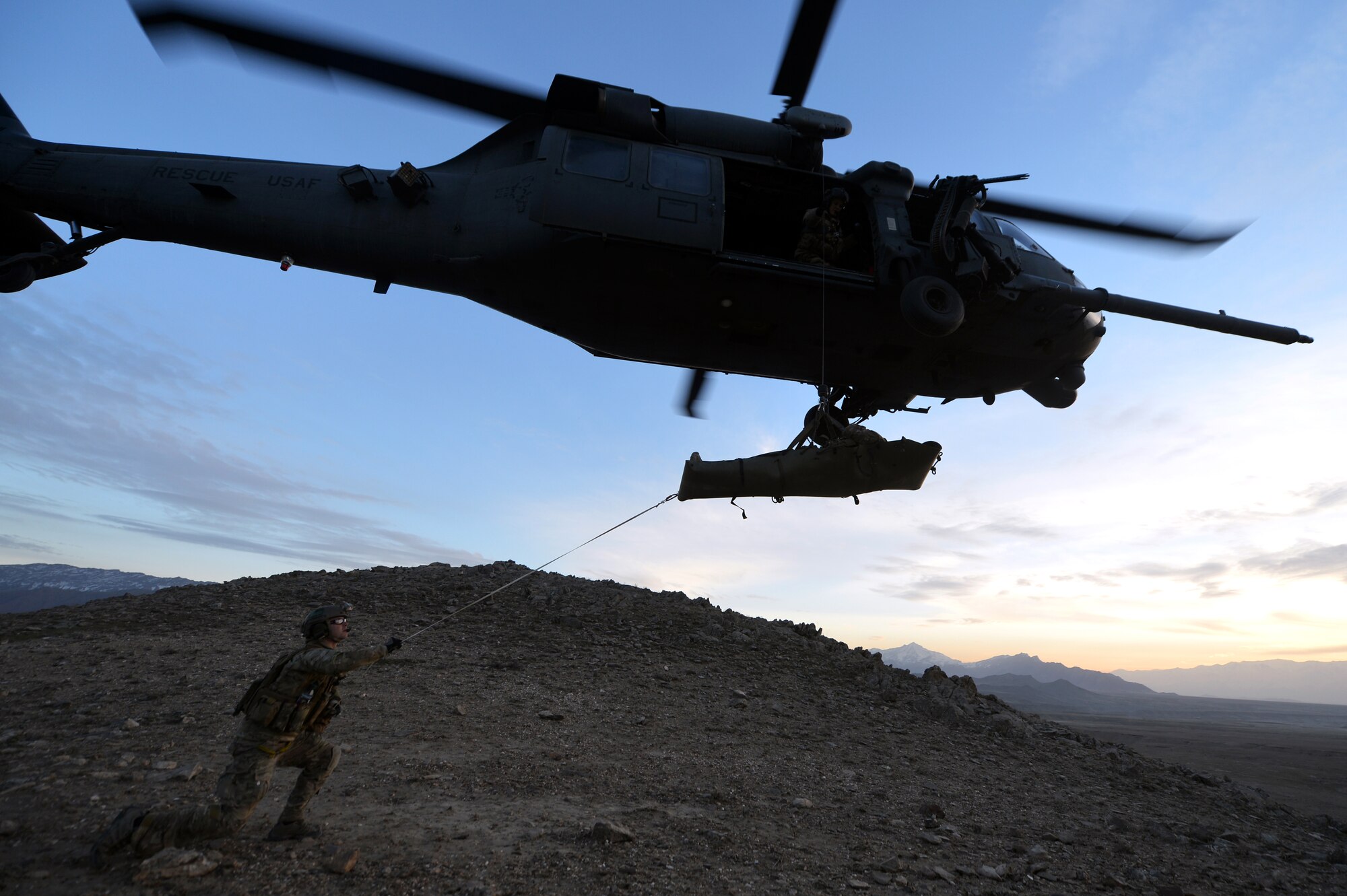 Members of the 83rd Expeditionary Rescue Squadron Guardian Angel transport a patient using an HH-60G Pave Hawk during a training mission outside of Bagram Airfield, Afghanistan, March 12, 2013. The 83rd ERQS Guardian Angel’s mission is to rescue, recover and return American or allied forces in times of danger or extreme duress.  (U.S. Air Force photo/Senior Airman Chris Willis)
