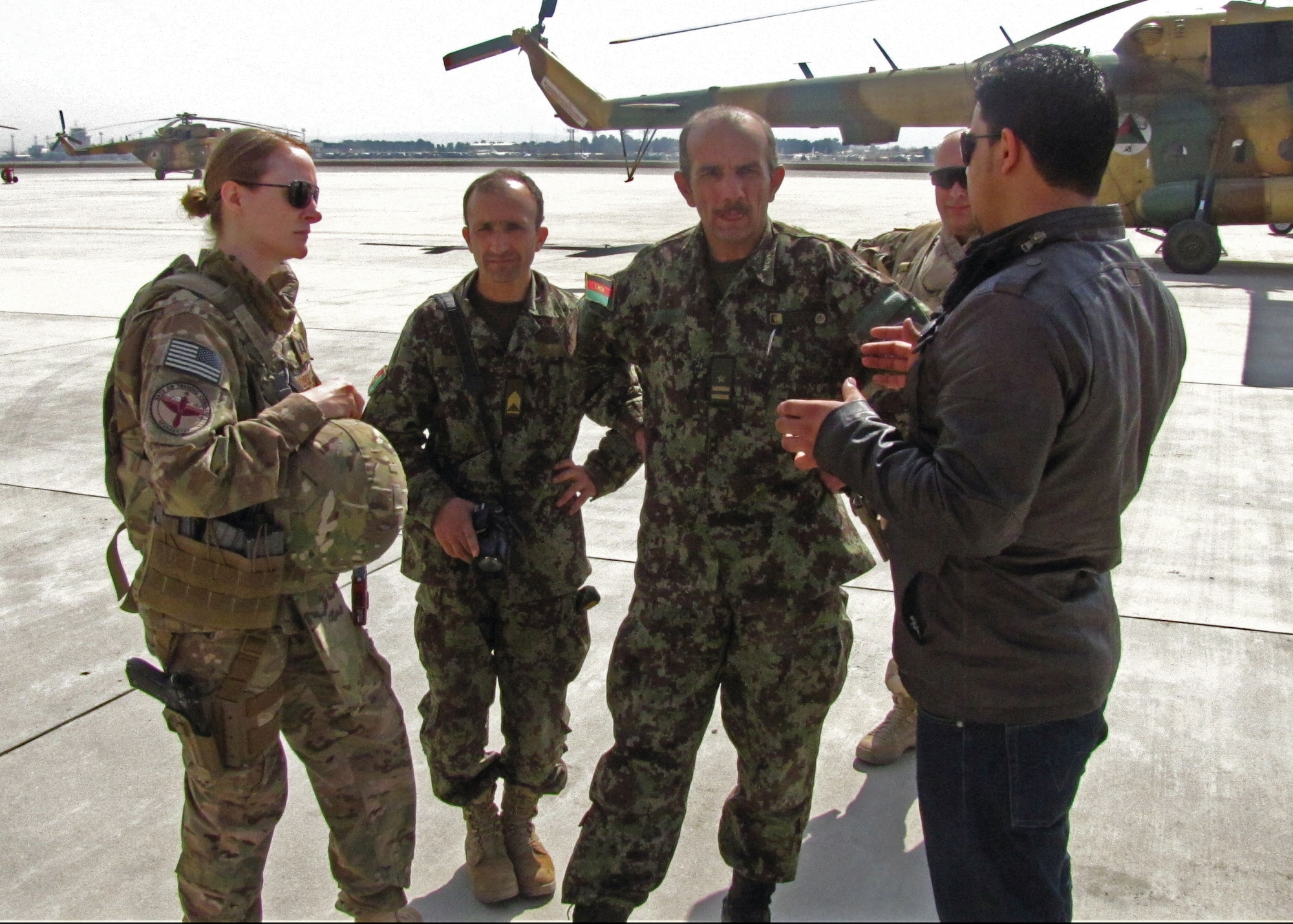 Capt. Anastasia Wasem, an air advisor with the 438th Air Expeditionary Wing, talks to her interpreter and two Afghan Air Force public affairs airmen during an International Women’s Day event at Kabul International Airport on March 7, 2013. Wasem trains and advises the AAF on how to conduct public affairs. “I love working with the Afghans, and this job allows me to feel like I’m making a difference,” she said. (U.S. Air Force photo/Capt. Tristan Hinderliter) 