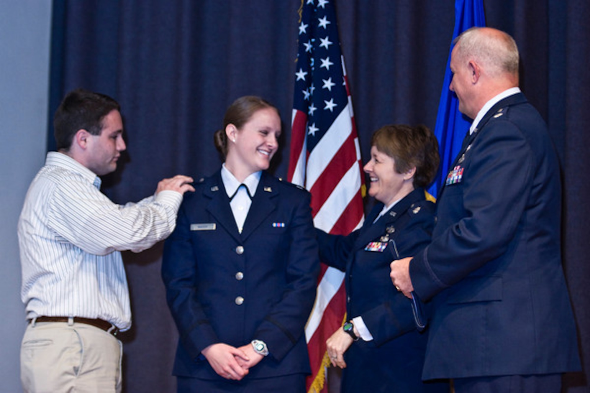 Capt. Anastasia Wasem, an air advisor with the 438th Air Expeditionary Wing, has her rank pinned on by her brother, Joe, and mother, Marcia, during her Reserve Officer Training Corps commissioning ceremony at the University of Washington, Seattle, in June 2008. Both of Wasem’s parents served in the Air Force and retired as lieutenant colonels. (Courtesy photo) 