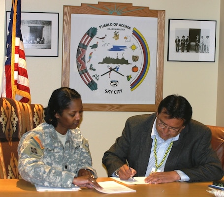 ACOMA PUEBLO, N.M., -- Albuquerque District Commander Lt. Col. Antoinette R. Gant watches as Acoma Pueblo Gov. Gregg P. Shutiva signs a Watershed Cost Share Agreement with the District March 6, 2013. The agreement is only the second such agreement across the Corps under the Section 203 Tribal Partnership Program.