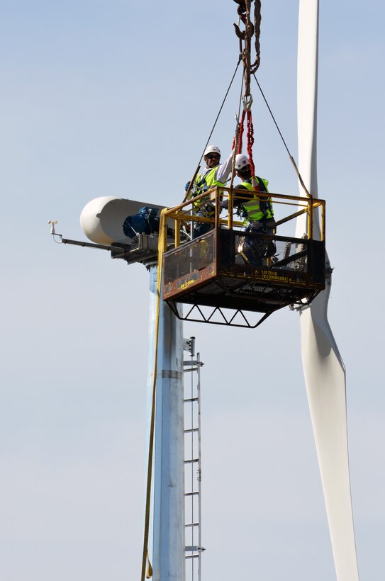Contractors are hoisted aloft to check the power head atop the 120-foot mast of the wind turbine during final assembly March 13, 2013, at Black Butte Lake, a U.S. Army Corps of Engineers Sacramento District park near Orland, Calif. Expected to go online within 30 days, the turbine can generate 11 kilowatts of energy and will help supply the needs of campers in the park.