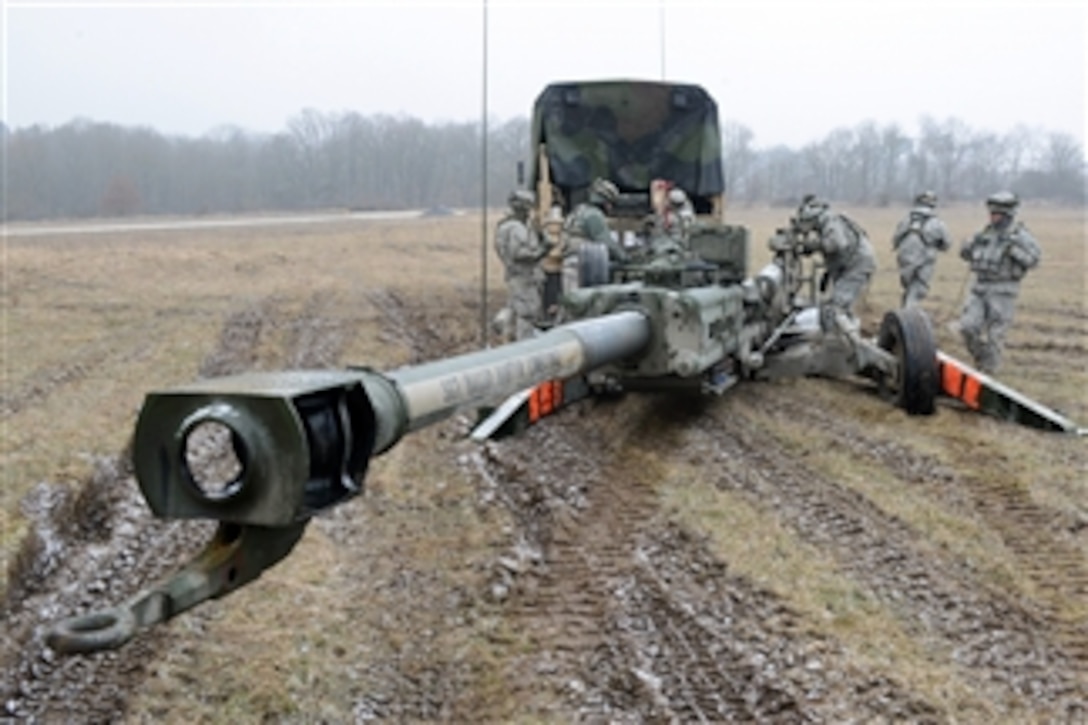 U.S.  Army soldiers assigned to Bulldog Battery, Field Artillery Squadron, 2nd Cavalry Regiment prepare for a fire mission with an M777A2 towed 155 mm howitzer during the regiment's mission rehearsal exercise at the Grafenwoehr Training Area, in Grafenwoehr, Germany, on March 12, 2013.  The rehearsal exercises develop combat skills, counterinsurgency tactics and interoperability between military forces of the U.S. and its partner nations before a scheduled deployment.  