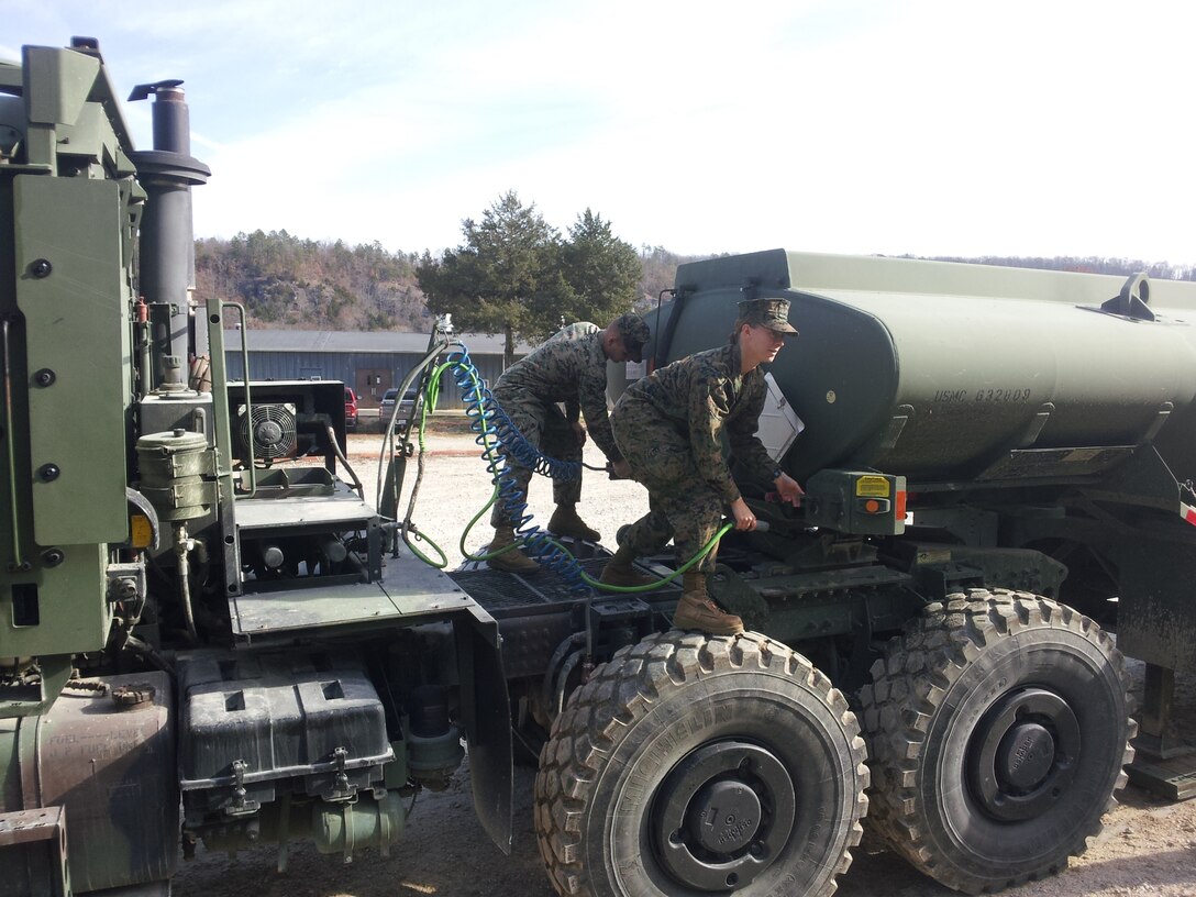 Lance Corporal Melissa L. Mueller from MWSS 271 and Lance Corporal Ryan T. Mann from CLR-2 perform Coupling and Uncoupling practical application of an AMK31 and MK970 on November 15, 2012 at Ft. Leonard Wood, MO while attending Semi-Refueler Operators Course 1-13. This is one of the first events students learn in the course prior to learning and performing tractor trailer operations and refueling operations.
