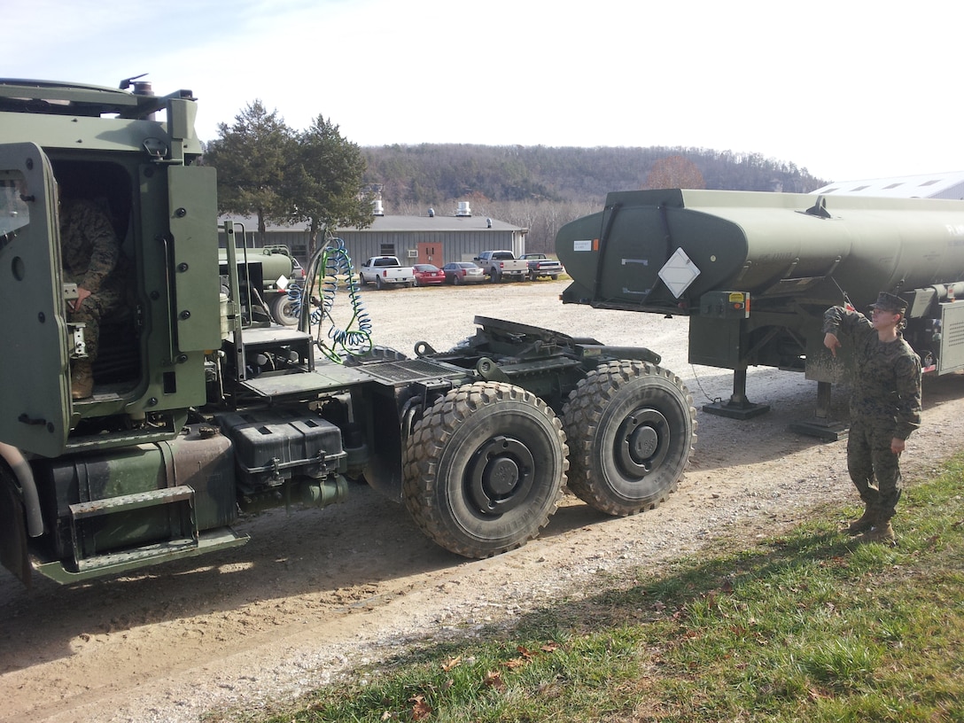Lance Corporal Melissa L. Mueller from MWSS 271 and Lance Corporal Ryan T. Mann from CLR-2 perform Coupling and Uncoupling practical application of AMK31 and MK970 on November 15, 2012 at Ft. Leonard Wood, MO while attending Semi-Refueler Operators Course 1-13. This is one of the first events students learn in the course prior to learning and performing tractor trailer operations and refueling operations.