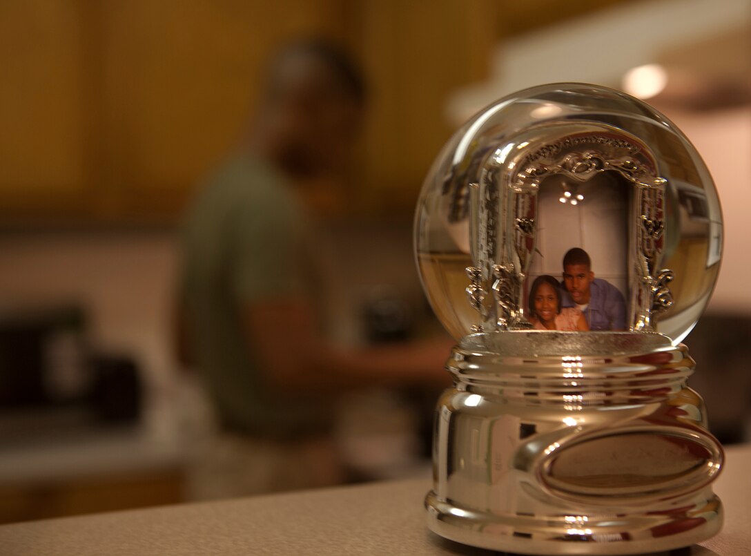 MARINE CORPS BASE HAWAII - A photo of Sgt. Kendall Joseph and Sgt. JaLisa Joseph within a snow globe on their kitchen countertop as they cook dinner together in their house on Marine Corps Base Hawaii, March 11, 2013. The Joseph family has fought hard for harmony with determination to succeed as Marines and husband and wife. (U.S. Marine Corps photo by Lance Cpl. Suzanna Lapi)