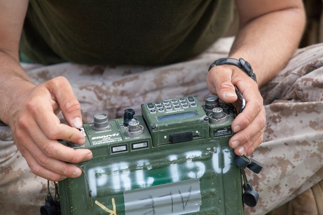 MARINE CORPS BASE HAWAII - Cpl. Brian Prins, a field radio operator with 2nd Battalion, 3rd Marine Regiment, and native of Grand Rapids, Mich., sets up communications through a single channel ground and airborne radio system aboard Marine Corps Base Hawaii, March 12, 2013. (U.S. Marine Corps photo by Lance Cpl. Jacob D. Barber)