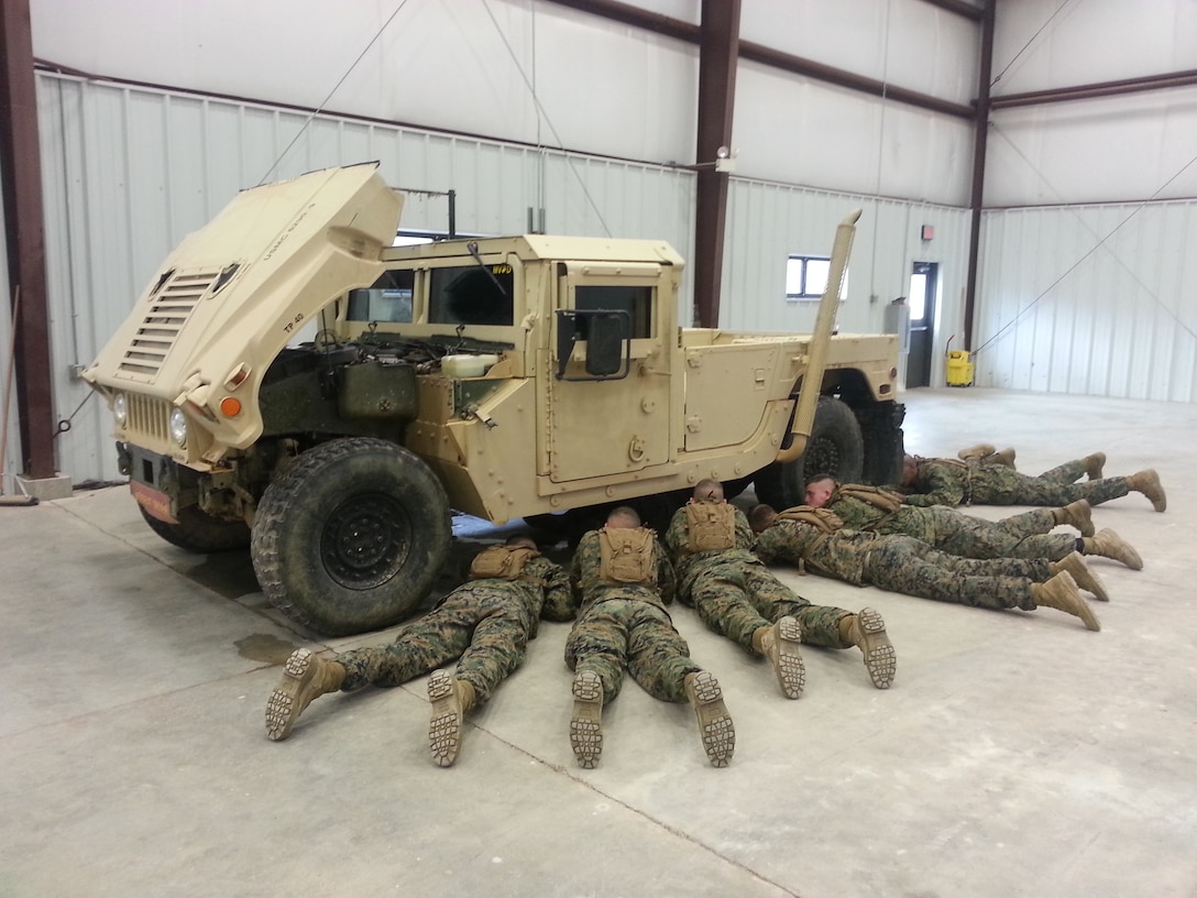 SSgt Duane Melendez gets hands on with his students to instruct the new class of MVOC Charlie 15-13 students on Preventive Maintenance Checks and Services on the M1152 HMWWV during the MVOC training at Ft. Leonard Wood, March 5, 2013.