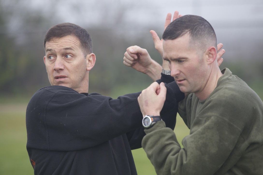 MARINE CORPS BASE CAMP PENDLETON, Calif. - Maj. Louis Lecher, the operations officer, demonstrates a counter to the round punch as part of a physical training session here. Marines and Sailors with the 11TH Marine Expeditionary Unit participate in unit physical training on Camp Pendleton, Calif, March 15, 2013. Integrating Marine Corps Martial Arts Program, The 11TH MEU is currently in post-deployment training.(Marine Corps Photo by Cpl. Jonathan Waldman/released)