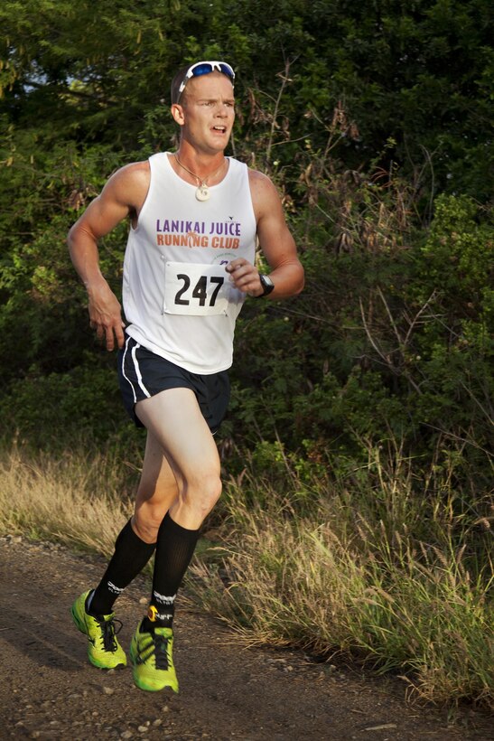 MARINE CORPS BASE HAWAII - Petty Officer 2nd Class Kyle Wiewiorski, an electrician mate with the Pearl Harbor Naval Shipyard and Intermediate Maintenance Facility at Joint Base Pearl Harbor-Hickam and native of Kailua, Hawaii, treks by the Nuupia Ponds on a dirt path during “The Beast” 10-kilometer race, March 9.(U.S. Marine Corps photo by Lance Cpl. Nathan Knapke)