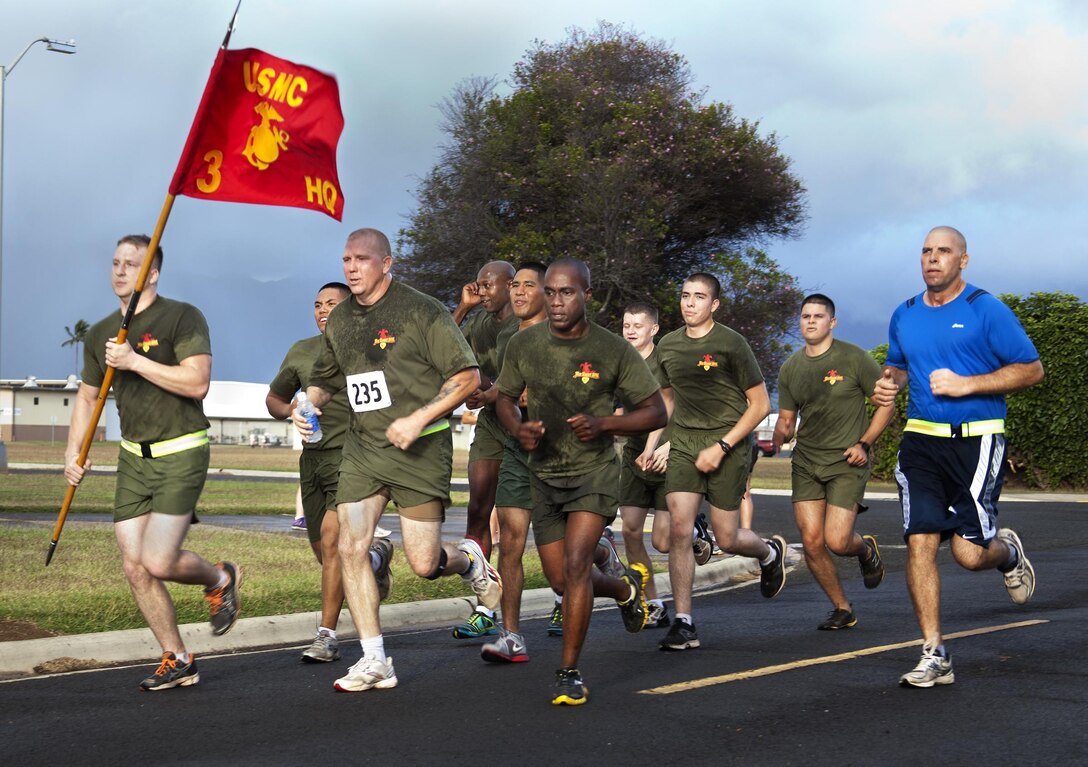 MARINE CORPS BASE HAWAII - A group of 10 Marines from 3rd Marine Regiment run to the finish line during “The Beast” 10-kilometer race, March 9. The top three finishers in each division received award plaques while raffle winners got gift cards and other prizes.(U.S. Marine Corps photo by Lance Cpl. Nathan Knapke)
