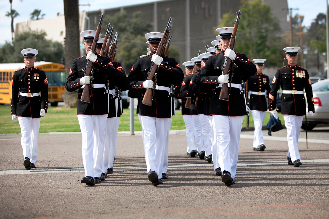 The Silent Drill Platoon marches toward the field where more than 1,000 spectators were in attendance during the Battle Color Ceremony at the Paige Fieldhouse Football Field here March 15.