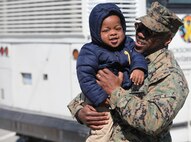 Marines and sailors with Black Sea Rotational Force 13 deployed from Marine Corps Base Camp Lejeune, N.C., to Eastern Europe today for a six-month tour. First Sgt. Charles McDew holds his grandson one more time before getting on the bus.