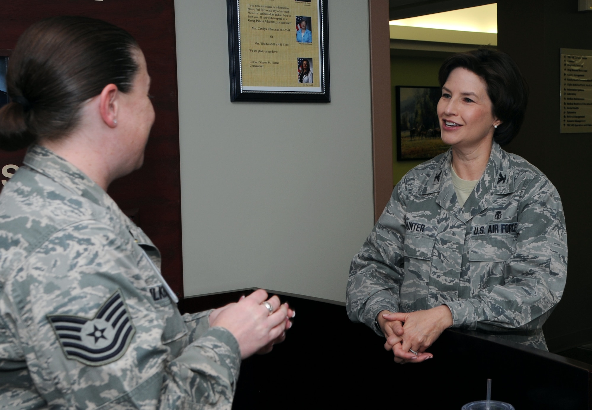 ALTUS AIR FORCE BASE, Okla. – Col. Sharon Hunter, 97th Medical Group commander, speaks with Tech. Sgt. Michelle Wilkerson, 97th Medical Support Squadron NCO in charge of TriCare operation and patient administration, at the 97th MDG front clinic, March 14. Hunter hopes that by being an Air Force leader and by upholding the Air Force core values, she inspires Airmen and young women today. (U.S. Air Force photo by Airman 1st Class Klynne Pearl Serrano / Released)