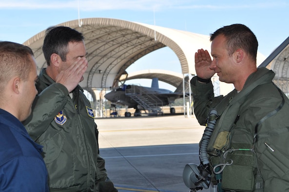 EGLIN AIR FORCE BASE, Fla. -- (Far right) Maj. Joseph Scholtz, 706th Fighter Squadron operational test pilot, salutes Col. Andrew Toth, 33rd Fighter Wing commander, upon completion of his first training sortie in the F-35 II Lightning here Oct. 30, 2012. Scholtz is a reservist assigned to Nellis Air Force Base, Nev., as the installation's first qualified F-35 pilot. (photo courtesy of 53rd Wing public affairs)