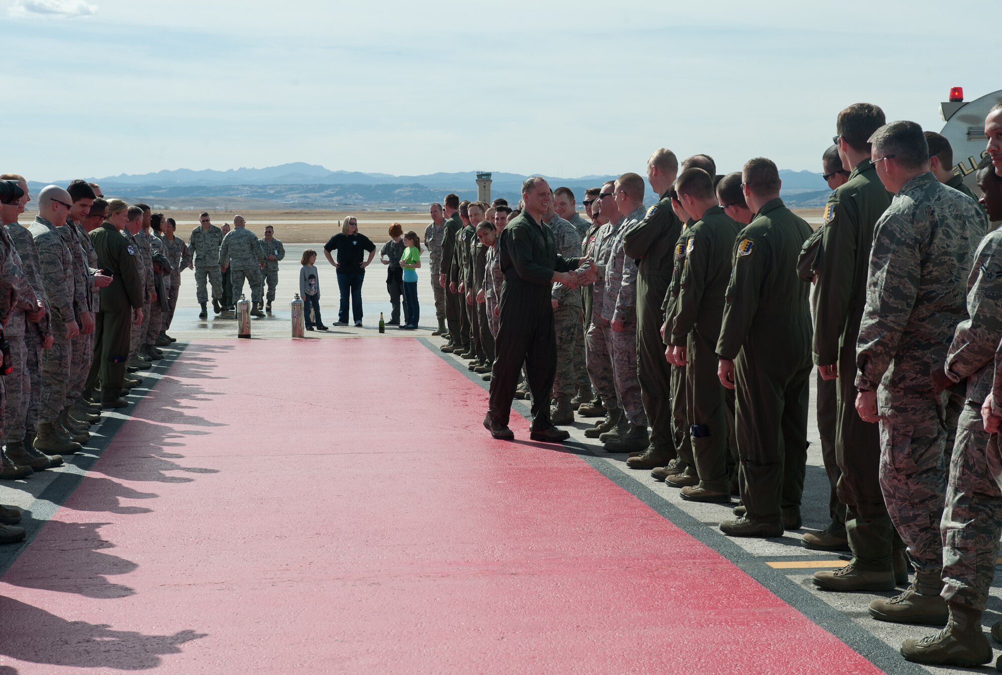 Col. Mark Weatherington, 28th Bomb Wing commander, shakes hands with Airmen after completing his end of tour flight at Ellsworth Air Force Base, S.D., March 14, 2013. Many of Weatherington’s fellow Airmen turned out to greet him on the completion of this significant milestone of his career.  (U.S. Air Force photo by Airman 1st Class Alystria Maurer/Released)