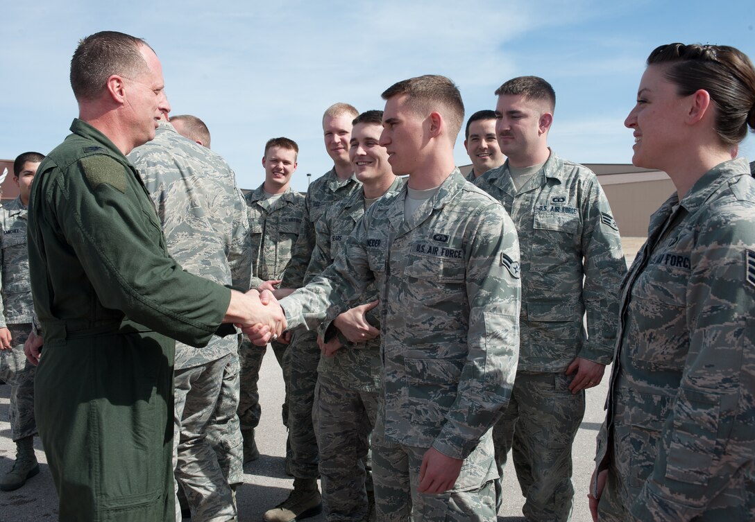 Airman 1st Class Brody Schneider, 28th Operations Support Squadron air traffic control technician, congratulates Col. Mark Weatherington, 28th Bomb Wing commander, after his final flight at Ellsworth Air Force Base, S.D., March 14, 2013. Col. Kevin Kennedy, currently the director of the Air Force Chief of Staff’s Strategic Studies Group at the Pentagon in Washington D.C., will take the helm of the 28th BW, April 5. (U.S. Air Force photo by Airman 1st Class Alystria Maurer/Released)