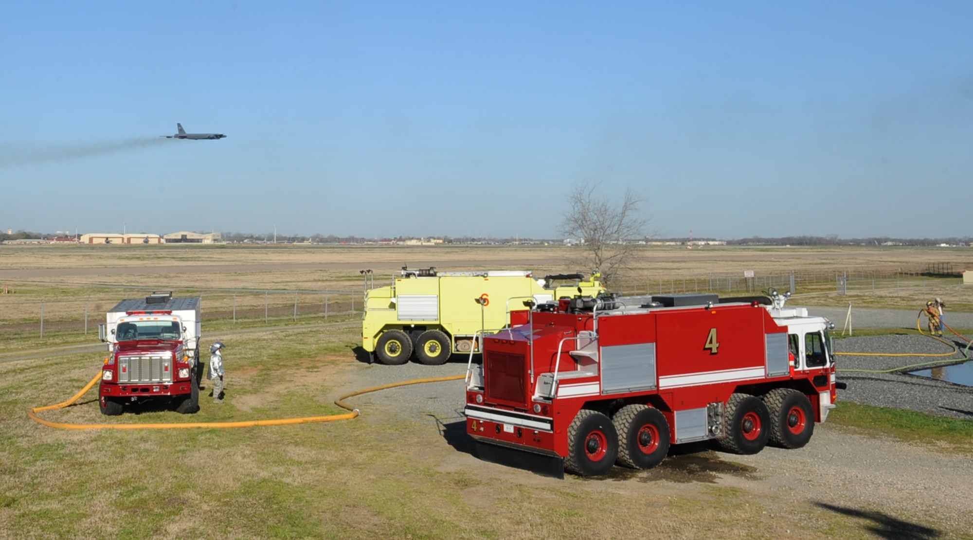 Firefighters from the 2nd Civil Engineer Squadron standby during a joint training exercise on Barksdale Air Force Base, La., March 15. The Shreveport Fire Department teamed up with Airmen from the 2 CES fire department to conduct their annual aircraft training. (U.S. Air Force photo/Senior Airman Sean Martin)
 
