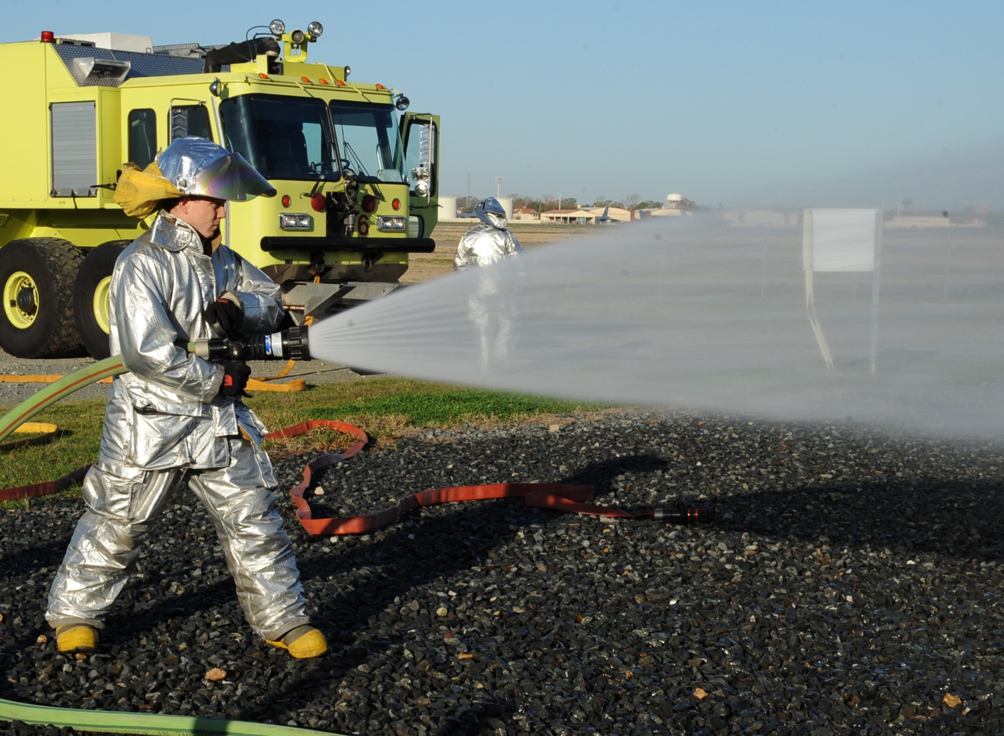 Senior Airman Kasey Hair, 2nd Civil Engineer Squadron crew chief and driver, tests a fire hose during a joint training exercise on Barksdale Air Force Base, La., March 15. The exercise was a way for Barksdale fire fighters and their off-base counterparts to train and learn from each other. (U.S. Air Force photo/Senior Airman Sean Martin)