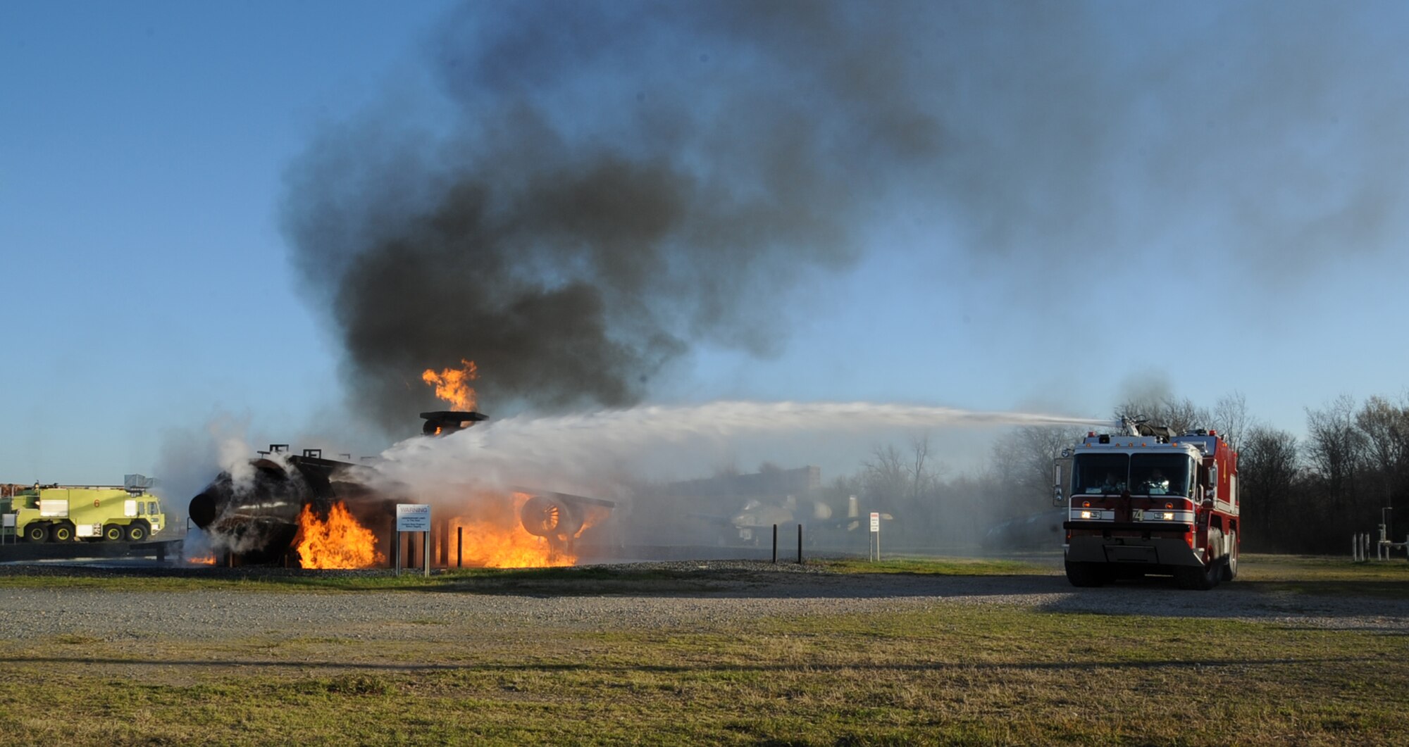 A fire truck from the 2nd Civil Engineer Squadron extinguishes a fire during a joint training exercise on Barksdale Air Force Base, La., March 15. The Shreveport Fire Department teamed up with Airmen from the 2 CES fire department to conduct their annual aircraft training. (U.S. Air Force photo/Senior Airman Sean Martin)