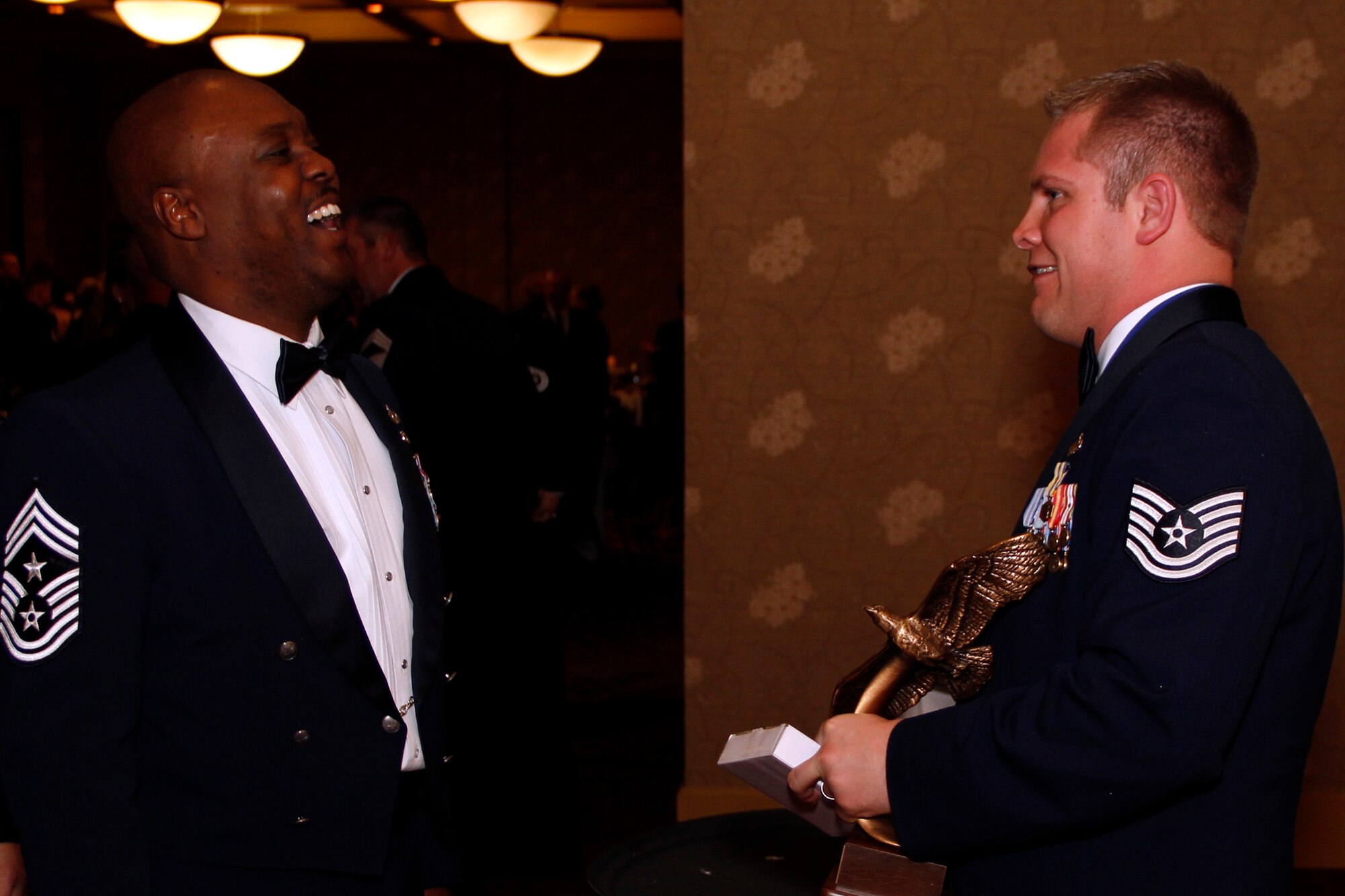 Chief Master Sgt. Otis Jones, 302nd Airlift Wing command chief, congratulates Tech. Sgt. Cory Slater, avionics quality assurance inspector and active duty maintenance squadron production supervisor, 52nd Airlift Squadron, on being the 302nd AW 2012 Noncommissioned Officer of the Year during the wing’s Annual Award Banquet held March 2 at the Crowne Plaza hotel, Colorado Springs, Colo. (U.S. Air Force photo/Staff Sgt. Nathan Federico)