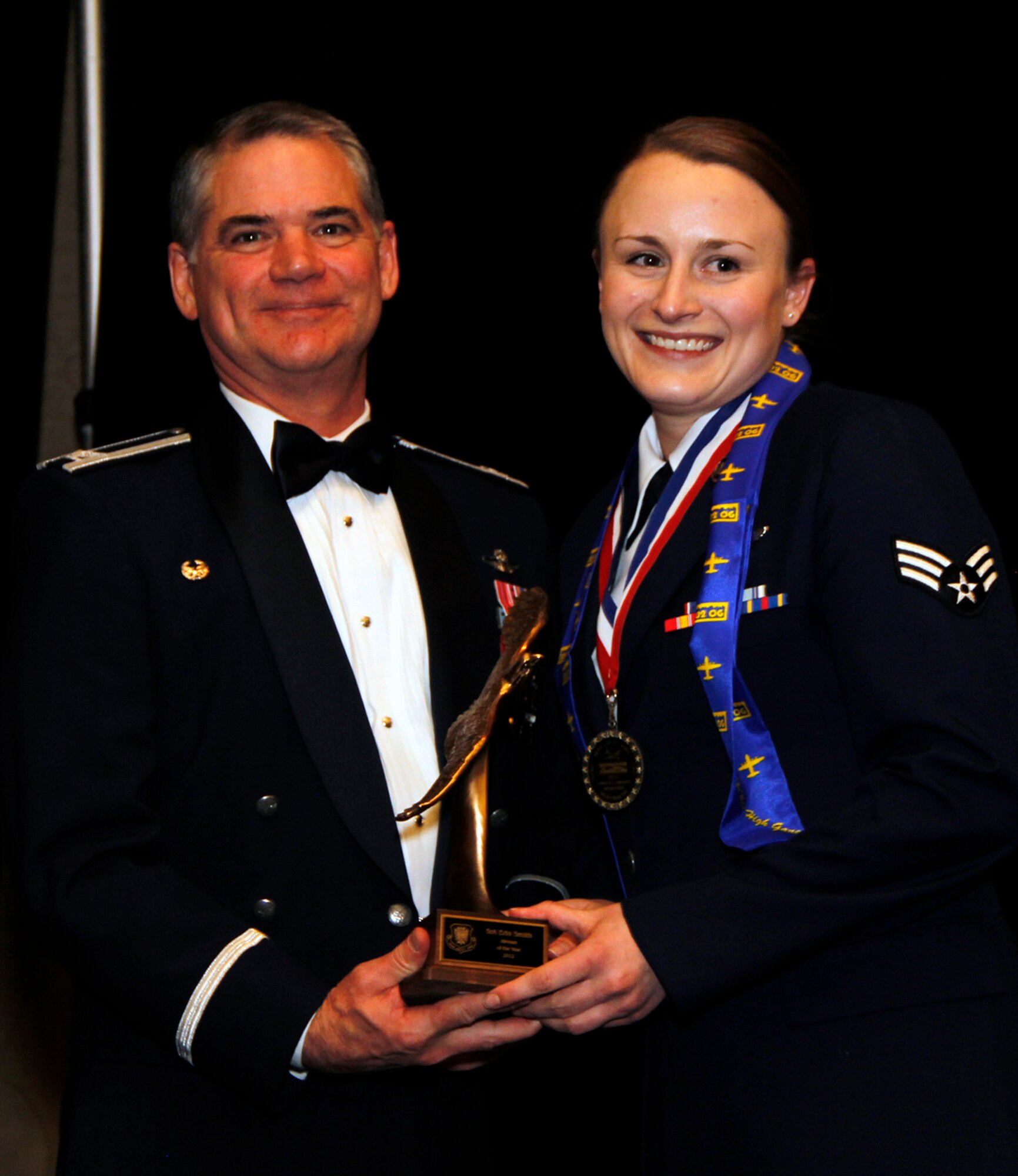 Senior Airman Erin Smith, a medical technician with the 34th Aeromedical Evacuation Squadron, is presented with the 302nd Airlift Wing 2012 Airman of the Year Award by Col. Jay Pittman, 302nd AW commander, during the wing’s Annual Award Banquet held March 2 at the Crowne Plaza hotel, Colorado Springs, Colo. (U.S. Air Force photo/Staff Sgt. Nathan Federico)