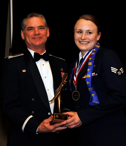 Senior Airman Erin Smith, a medical technician with the 34th Aeromedical Evacuation Squadron, is presented with the 302nd Airlift Wing 2012 Airman of the Year Award by Col. Jay Pittman, 302nd AW commander, during the wing’s Annual Award Banquet held March 2 at the Crowne Plaza hotel, Colorado Springs, Colo. (U.S. Air Force photo/Staff Sgt. Nathan Federico)