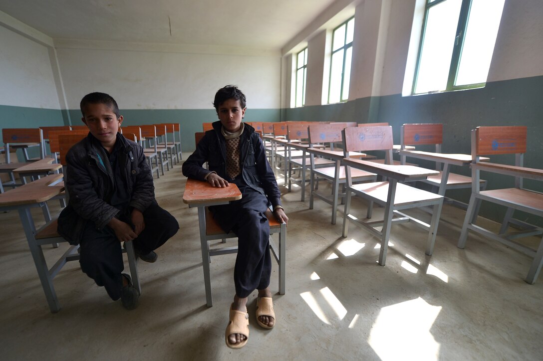 Afghan schoolchildren show off their classroom at a school near Bagram Airfield, Afghanistan, March 11, 2013. The 755th Expeditionary Security Forces Squadron Reaper team operates missions “outside the wire” providing security during key leader engagements and meetings with the local community. (U.S. Air Force photo/Senior Airman Chris Willis)