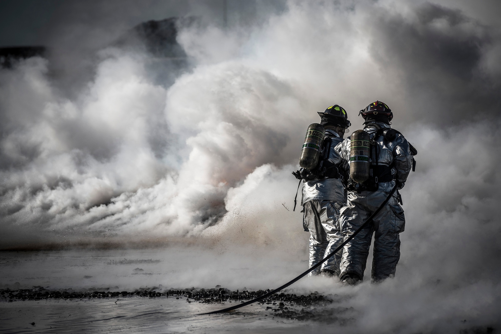 MOUNTAIN HOME AIR FORCE BASE, Idaho -- Firefighters from the 366th Civil Engineer Squadron extinguish a fire during a live fire training exercise as part of a base-wide operational readiness exercise March 4, 2013, at Mountain Home Air Force Base, Idaho. Two teams had to work in unison to push the fire back without it reigniting behind them. (U.S. Air Force photo/Tech. Sgt. Samuel Morse)