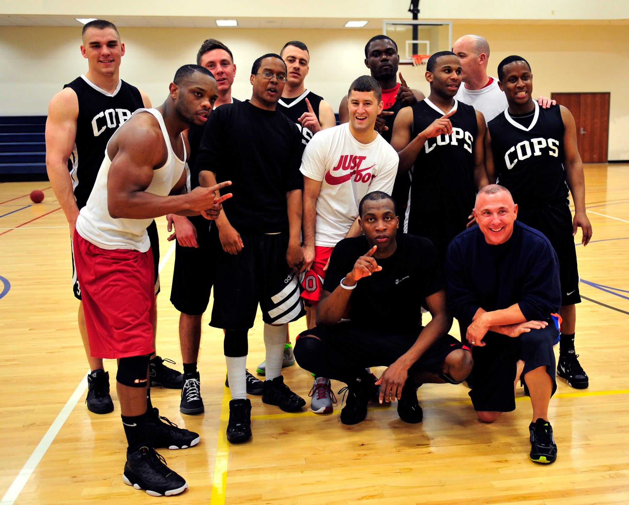 The 460th Security Forces Squadron intramural basketball team celebrates their first-place victory during the base championship game March 13, 2013, on Buckley Air Force Base, Colo. The 460th SFS team was victorious over the 566th Intelligence Squadron, who returned to the base championships for their second consecutive year. (U.S. Air Force photo by Airman 1st Class Darryl Bolden Jr. /Released)