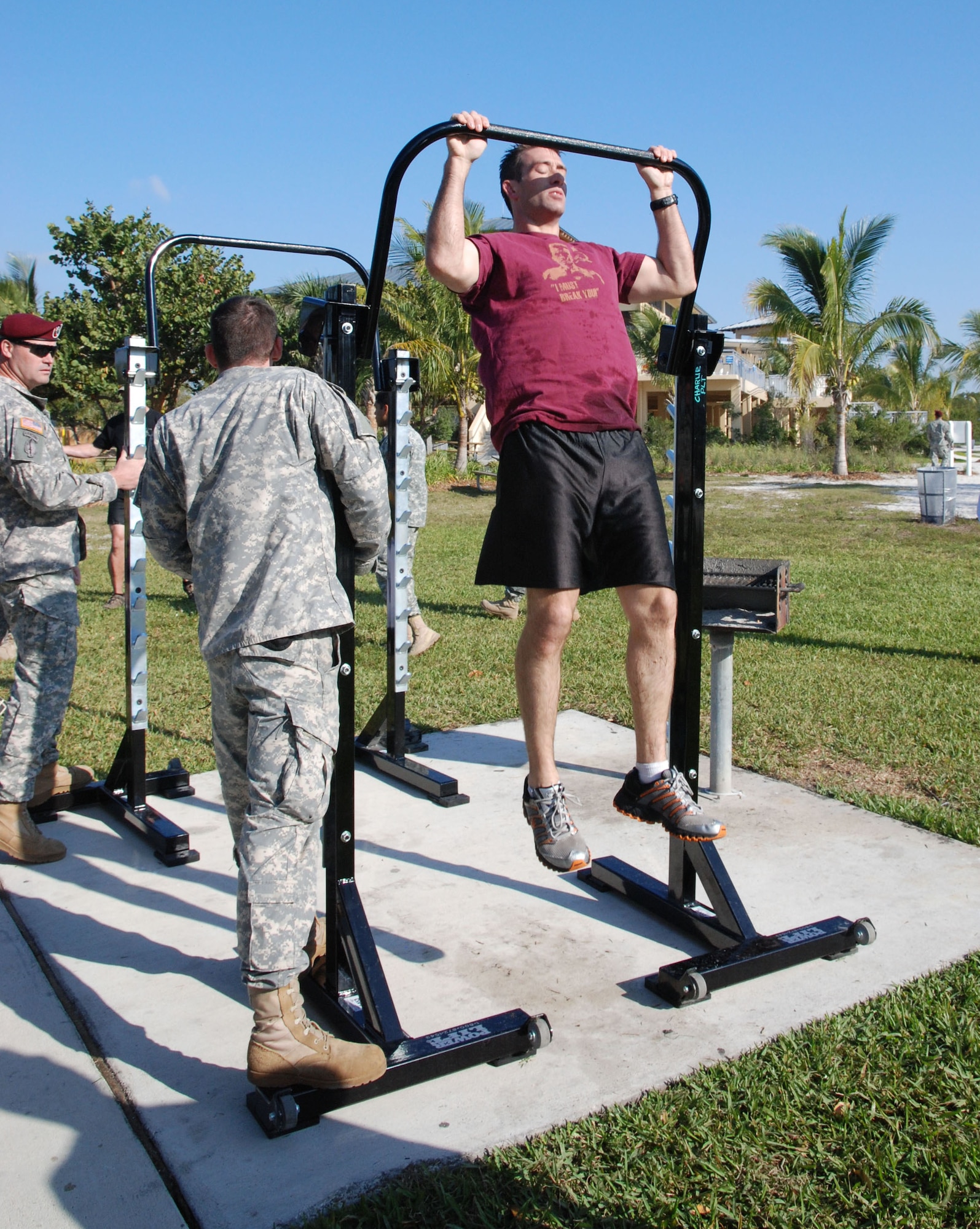 Army Maj. Colin Johnson displays his strength at the pull-up station during the physical fitness event of the Special Operations Command South Warrior Challenge at Homestead Bayfront Park March 8. The challenge featured several physical fitness and military skills events such as a 4.5 mile run, weapons malfunction and assembly station, and 4.5 mile ruck march. The event consisted of 21 teams assigned to SOCSOUTH competing for bragging rights among the unit. The competition allowed for members of the command to enjoy a day of fun and help build its esprit de corps. The event ended with a command barbeque. (DOD photo by Army Capt. Daisy Bueno, SOCSOUTH Public Affairs)  