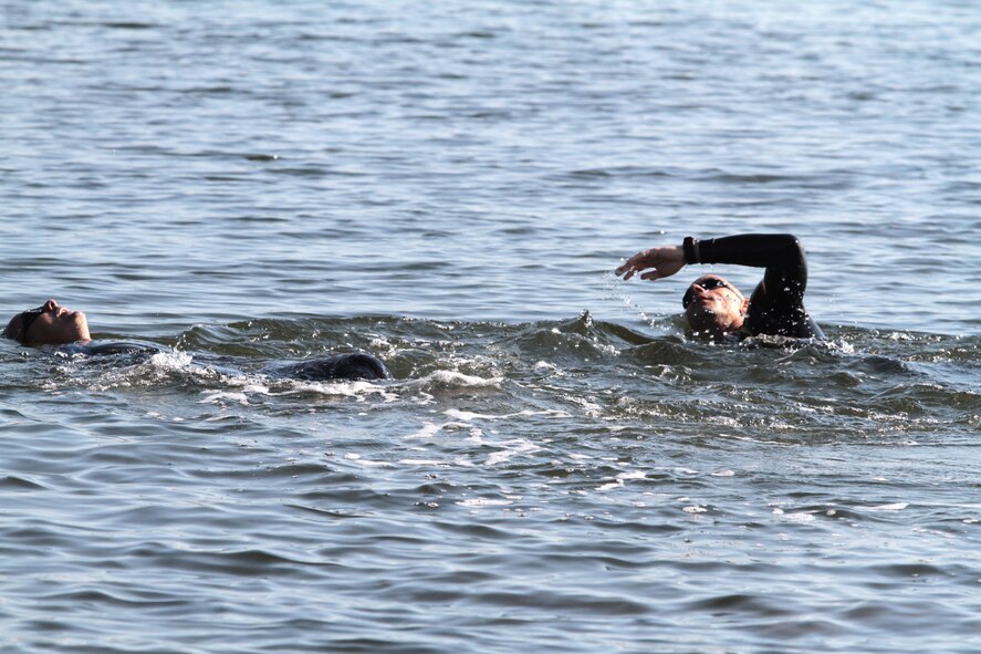 Army Sgt. 1st Class Ademar Cubero (left) and Air Force Capt. Robert Lax swim 500 meters along the Homestead Bayfront Park shoreline during the Special Operations Command South Warrior Challenge March 8.  The challenge featured several physical fitness and military skills events such as a 4.5 mile run, weapons malfunction and assembly station, and 4.5 mile ruck march. The event consisted of 21 teams assigned to SOCSOUTH competing for bragging rights among the unit. The competition allowed for members of the command to enjoy a day of fun and help build its esprit de corps. The event ended with a command barbeque. (DOD photo by Army Sgt. 1st Class Alex Licea, SOCSOUTH Public Affairs)