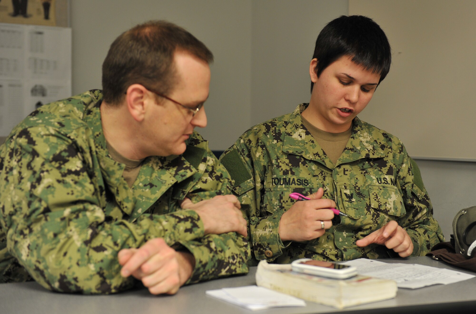 WHITEMAN AIR FORCE BASE, Mo. -- Petty Officer 2nd Class Jason Bartlett, and Petty Officer 3rd Class Tonja Toumasis, Coastal Riverine Squadron 11, Detachment Alpha 2 electric technician, study U.S. Navy history for an upcoming exam during their drill weekend, Feb. 9, 2013. Each reservist must maintain a security clearance, have a passport, be medically fit to fight, have a family care plan ready and be swim-qualified. (U.S. Air Force photo/Heidi Hunt) (Released)