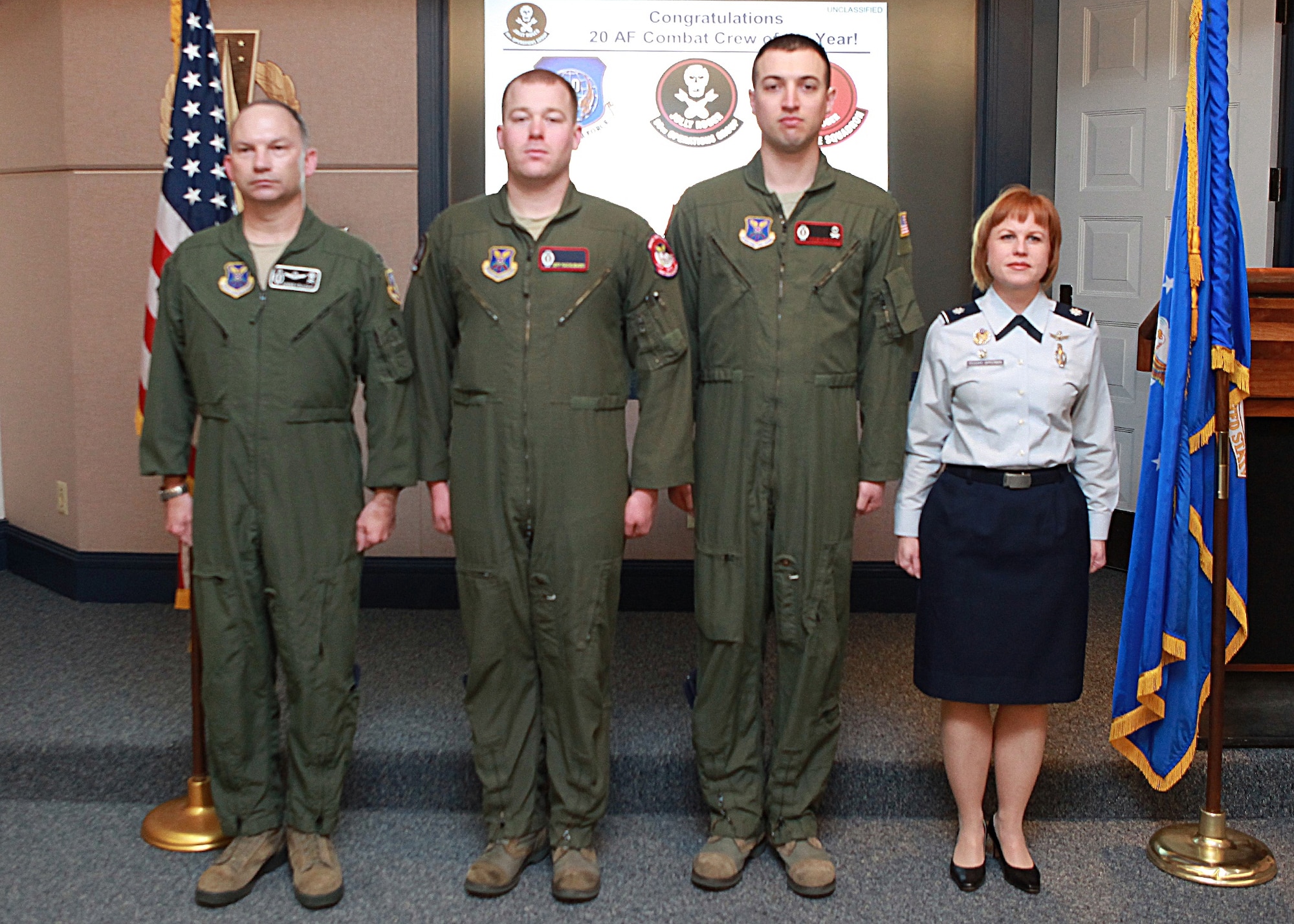Col. Donald Holloway, 90th Operations Group commander; 1st Lt. Jeff Maciejewski, 90th Operations Support Squadron; 1st Lt. Tyler Remkus, 320th Missile Squadron; and Lt. Col. Anita Feugate Opperman, 320th MS commander, pose for a photograph after Maciejewski and Remkus received Air Force Achievement Medals in the 90th OG headquarters March 6. (U.S. Air Force photo by Matt Bilden)