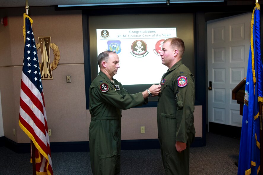 Col. Donald Holloway, 90th Operations Group commander, pins the Air Force Achievement Medal on 1st Lt. Jeff Maciejewski, 90th Operations Support Squadron, in the 90th OG headquarters March 6. Maciejewski and 1st Lt. Tyler Remkus, 320th Missile Squadron, (not pictured) earned Air Force Achievement Medals for their participation in Air Force Global Strike Challenge and for being named 2012 20th Air Force combat crew of the year. (U.S. Air Force photo by Matt Bilden)