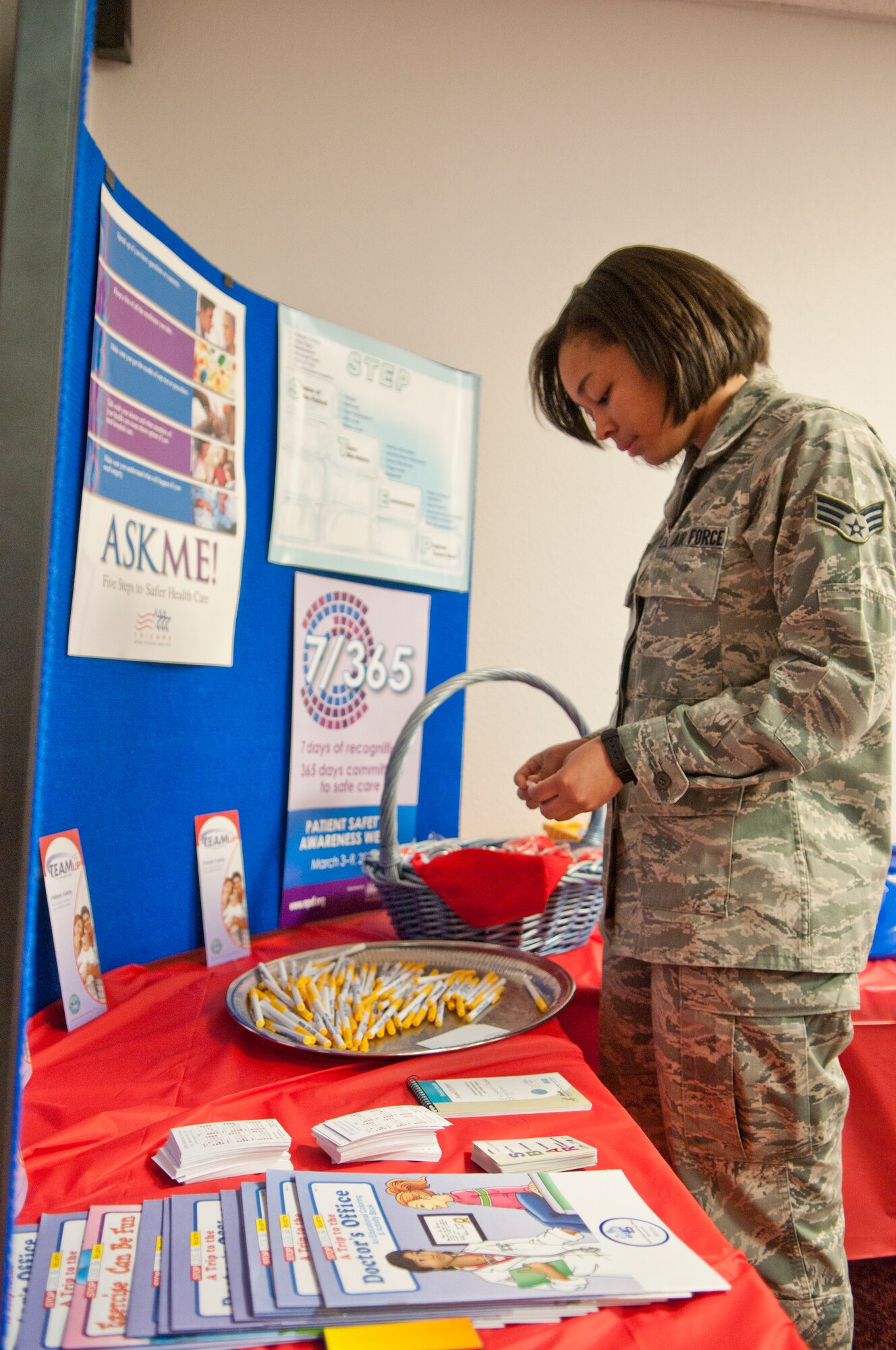 Senior Airman Crystal Wanton, 90th Medical Operations Squadron flight medicine, looks through the information at a National Patient Safety Awareness Week display. (U.S. Air Force photo by Airman 1st Class Jason Wiese)